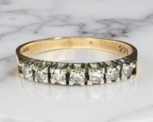 A 9ct yellow gold half eternity ring set with cubic zirconia, size N.
