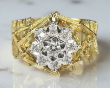 An 18ct yellow gold diamond cluster ring with textured shoulders, size M.