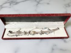 A 925 silver bracelet with heart shaped amethyst coloured stone,