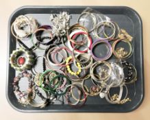 A collection of costume bangles, charm bracelet, etc.