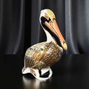 A Royal Crown Derby porcelain Brown Pelican paperweight, with gold stopper.