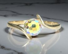 A 9ct yellow gold synthetic stone solitaire ring, size S. CONDITION REPORT: 1.7g.