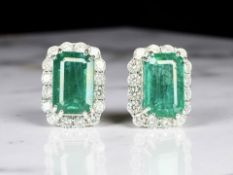 A pair of 18ct white gold emerald and diamond cluster earrings, emerald total 11.59ct diamond 2.