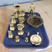 A brass figure of a miner, a group of graduated Victorian brass bell weights,