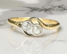 An 18ct yellow gold two stone diamond ring, size P. CONDITION REPORT: 1.9g.