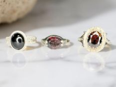 Three Sterling silver rings set with simulated stones.