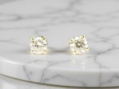 A pair of 18ct yellow gold diamond stud earrings, 0.7ct total. CONDITION REPORT: 0.