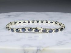 An 18ct white gold sapphire and diamond bracelet, total sapphire 12.5ct, length 17.