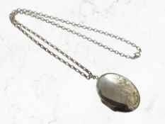 A silver locket suspended on silver chain, length 51 cm CONDITION REPORT: 21.