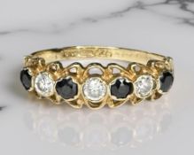 A 9ct yellow gold dress ring set with cubic zirconia and synthetic sapphire, size N/O.