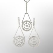 An 18ct white gold diamond and earring pendant suite.