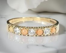 A 9ct yellow gold dress ring set with coral, size O. CONDITION REPORT: 1.6g.