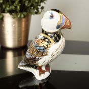 A Royal Crown Derby porcelain Puffin paperweight, with silver stopper.