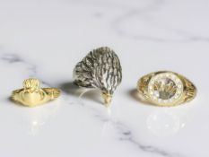 A silver gilt claddagh ring, an eagle head ring stamped 925 and a further gold plated ring.