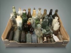 A collection of antique glass and stoneware bottles, chemist's bottles, etc.