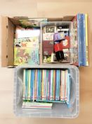 A collection of Disney books, past times postcard albums, several packs of playing cards.