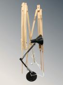 An enameled metal angle poised lamp, together with two adjustable wooden easels.