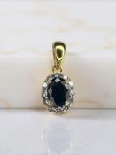 An 18ct gold sapphire and diamond cluster pendant