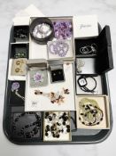 A collection of boxed costume jewellery including silver mounted pendants and necklaces,
