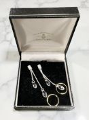 A pair of Swarovski crystal droplet earrings and a pair of silver gilt hoop earrings.