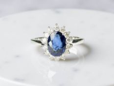 An 18ct white gold sapphire and diamond cluster ring, size N. CONDITION REPORT: 3.