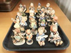 Twenty West German Goebel figures of boys and girls.