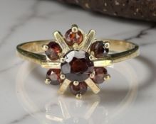 A 9ct yellow gold garnet cluster ring, size N. CONDITION REPORT: 2.2g.