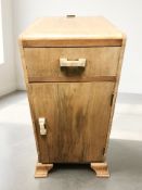 An Art Deco figured walnut bedside cabinet, height 72 cm.