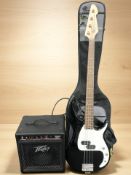 A Peavey Milestone BXP electric bass guitar, with a soft carry bag, and a PV micro bass amplifier.