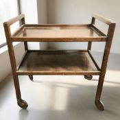 An early 20th century stained oak two tier serving trolley on castors, width 72 cm.