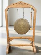 A late Victorian oak dinner gong, with beater, height 114 cm.