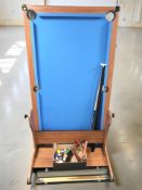 A 6 ft pool table with various cues, balls, etc.
