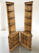 A pair of Ercol stained elm corner shelves, height 195 cm.
