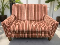 A contemporary two seater settee in striped red upholstery, width 127 cm.