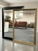 A reproduction black framed bevelled rectangular mirror, 110 cm x 79 cm,