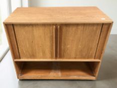 A 20th century teak sliding door record cabinet, 77 cm x 37 cm x 64 cm.