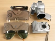 A pair of Ray-Ban sunglasses, two further unmarked pairs, with Ray-Ban leather glasses cases,