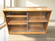 A 20th century teak sliding glass door low bookcase, width 110 cm.
