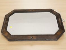 An Edwardian octagonal oak mirror, width 80 cm.
