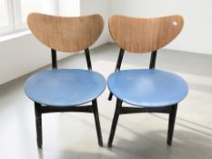 A pair of 20th century laminated teak and ebonised dining chairs with blue vinyl seat covers,