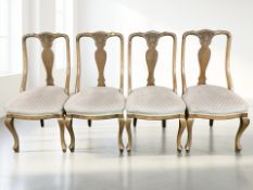 A set of four carved walnut and beech Queen Anne style dining chairs.