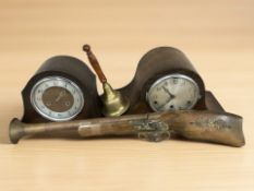 Two oak Art Deco mantel clocks, a brass hand bell and an ornamental musket.