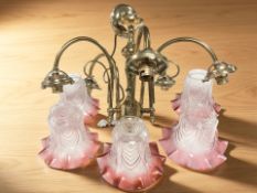 A vintage brass five-branch ceiling light fixture with two-tone pressed glass shades,