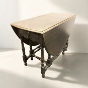 An Edwardian oak gate leg dining table, width 105 cm, together with a set of four chairs.