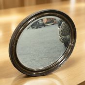 An Edwardian mahogany oval mirror, width 74 cm.