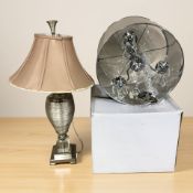 A contemporary Searchlight ceiling light fixture and a table lamp.