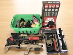A collection of spring-powered airsoft weapons, including one in the form of a Barrett sniper rifle,