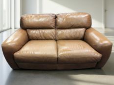 A contemporary stitched brown leather two seater settee, length 180 cm.