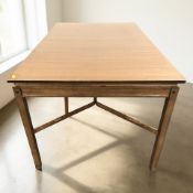 A 20th century teak pull-out extending dining table with internal leaf, on X-framed understretcher,