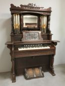 A late 19th century walnut Canadian pipe organ retailed by Waddington & Sons, Newcastle on Tyne,